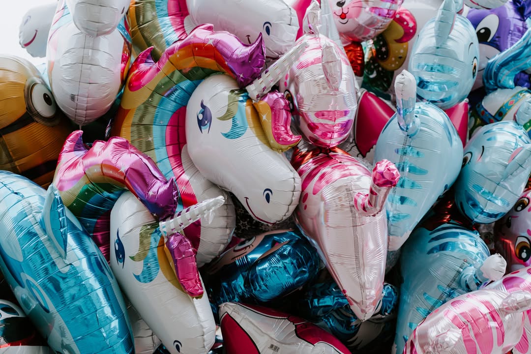 A photo of some colorful unicorn balloons - https://unsplash.com/purzlbaum
